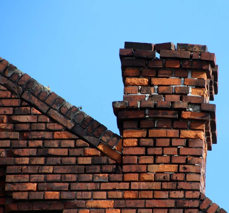 Damaged chimney on an Corinth home showing cracks and missing mortar